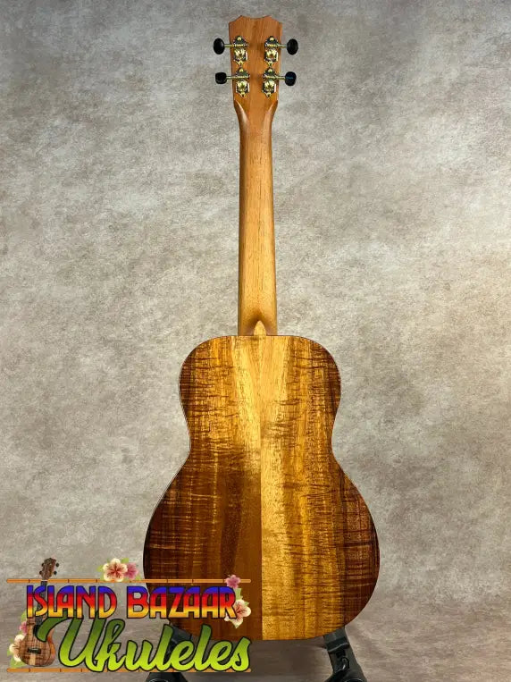 Light brown Kanile’a KPA Pro Tenor Koa Ukulele with rich wood grain and vertical stripe