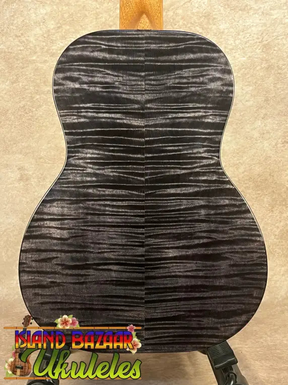 Black and gray figured wood guitar back on Kanileʻa Pōhaku T Pro Tenor Ukulele with solid maple