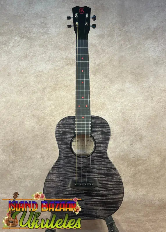 Black ukulele with red fret markers on Kanileʻa Pōhaku T Pro solid maple tenor ukulele