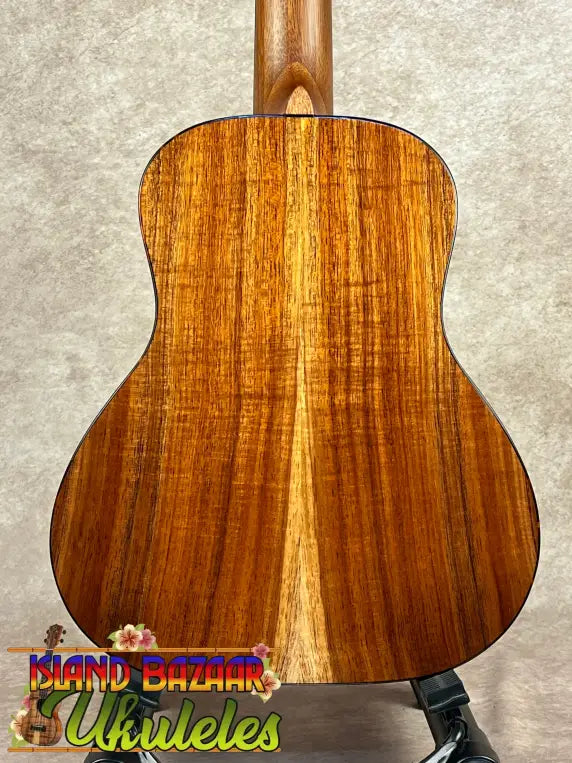 Back of a wooden acoustic guitar with koa grain pattern for Kanile’a Super Oha Series Ukulele