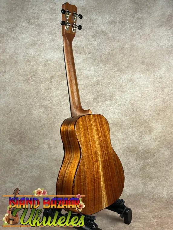 Wooden Kanile’a Super Oha Series Koa Ukulele with glossy finish and four tuning pegs