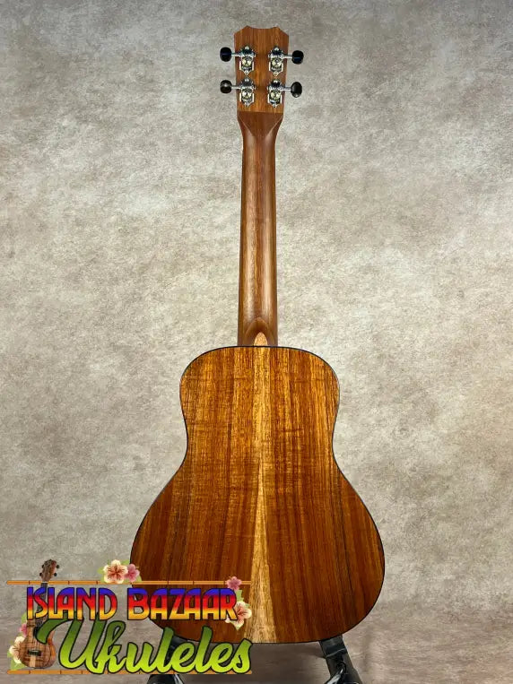 Kanile’a Super Tenor D-Hole Koa Ukulele with rich brown figured wood back and chrome tuning pegs