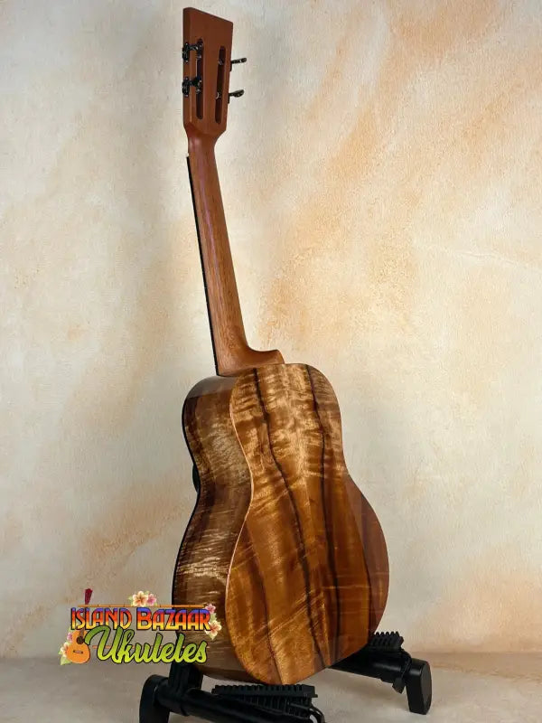 Wooden Kanile’a Super Tenor D-Hole Premium Koa Ukulele showcasing natural grain patterns