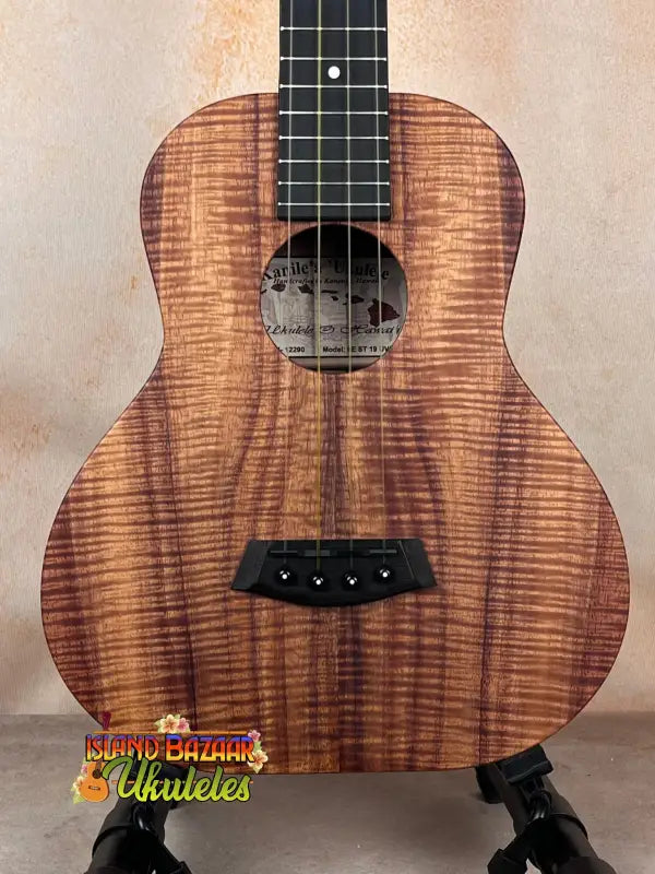 Kanile’a Super Tenor Ukulele in premium koa features striking grain and dark fretboard