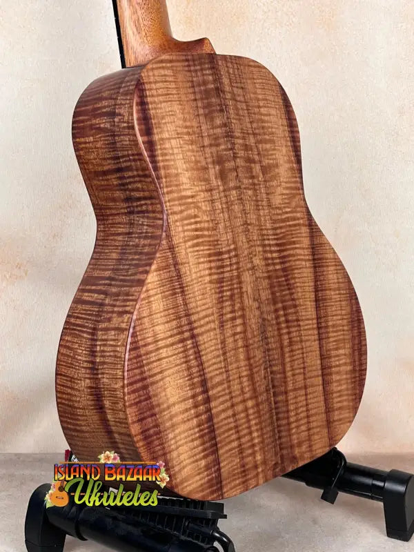 Acoustic guitar featuring striking figured koa wood grain pattern of Kanile’a Super Tenor