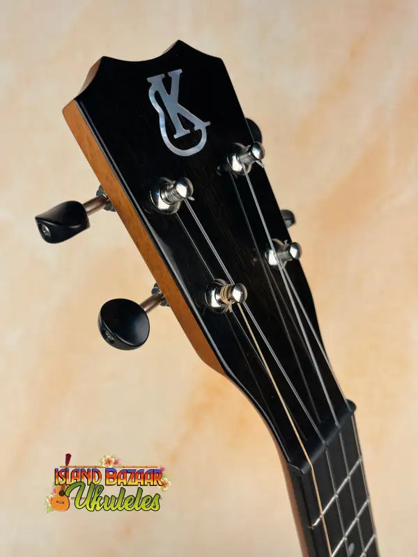 Black ukulele headstock with tuning pegs from Kanile’a Tenor D-1 with Deluxe Gig Bag