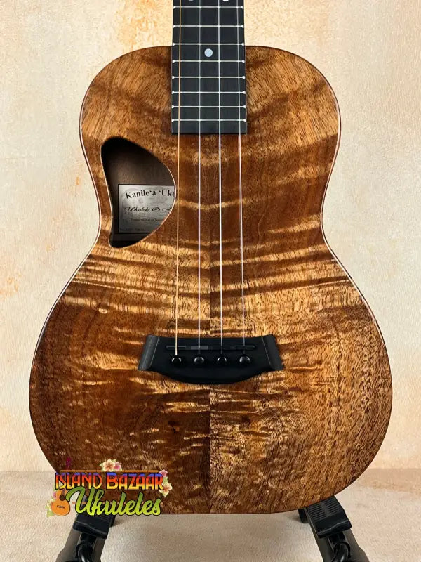 Brown wooden Kanile’a Tenor D-1 ukulele with solid Hawaiian Koa and deluxe gig bag