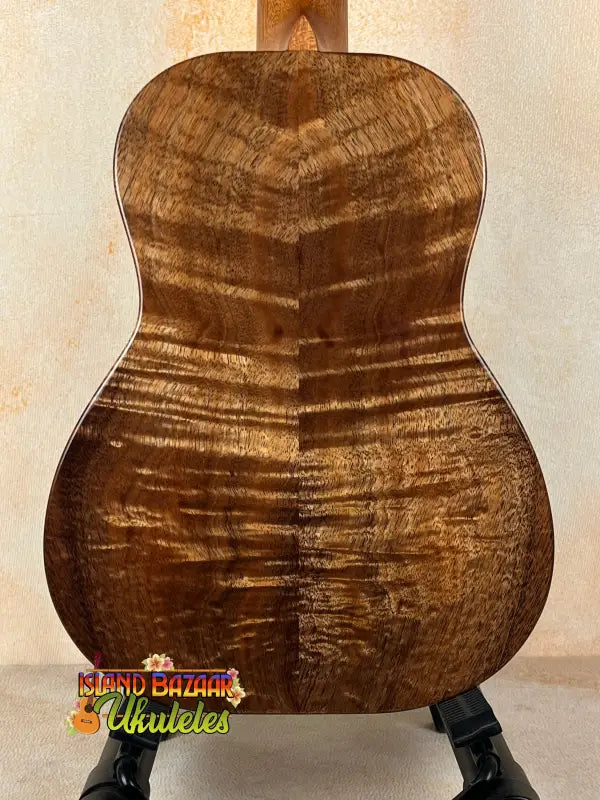 Wooden ukulele back featuring striking grain pattern of Kanile’a Tenor D-1 with deluxe gig bag