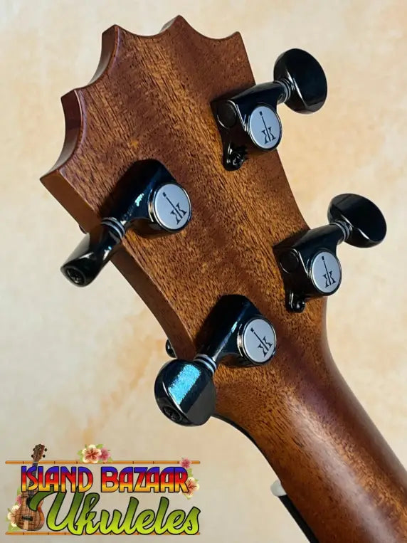 Guitar headstock with black tuning pegs and solid Hawaiian Koa featured in KoAloha KCM-10RP