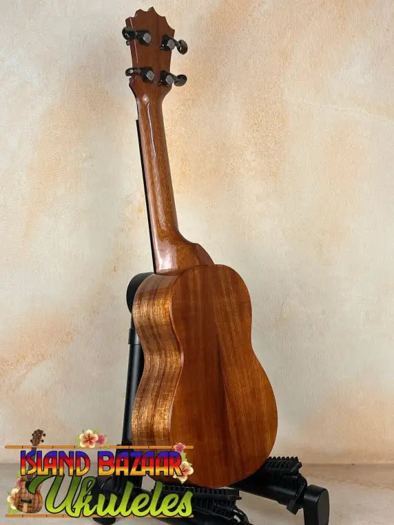 Wooden KoAloha KSM-00 ukulele on a black stand showcasing solid Hawaiian Koa craftsmanship