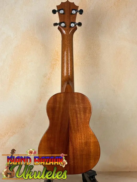 Wooden KoAloha KSM-00 featured soprano ukulele in natural finish on a black stand