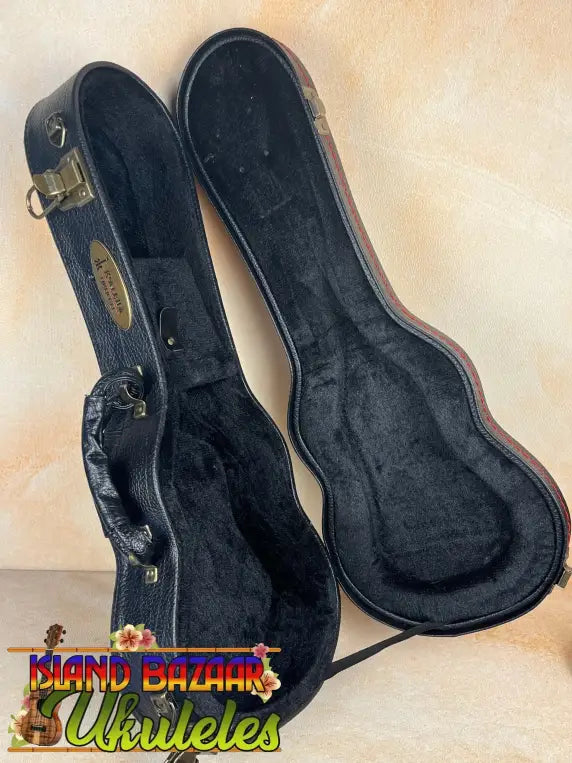 Black hardshell guitar case with plush lining for KoAloha KSM-00 featured soprano ukulele