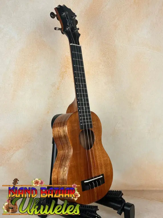 Wooden KoAloha KSM-00 Featured Soprano Ukulele with solid Hawaiian Koa on black stand
