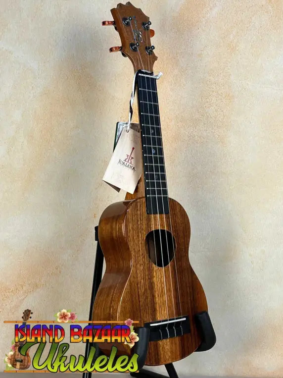 Wooden KoAloha KSM-00 Soprano Ukulele with Hawaiian Koa and Ebony Fretboard on stand