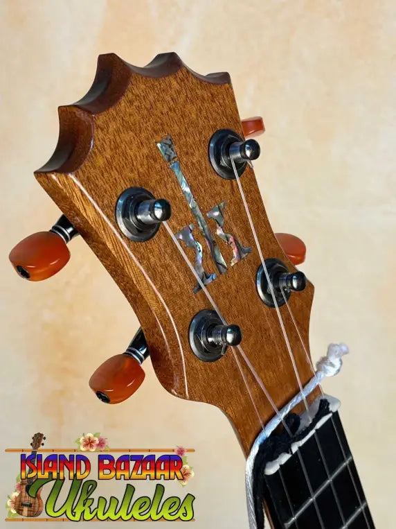 Guitar headstock with decorative inlay and tuning pegs on KoAloha KSM-00 Soprano Ukulele