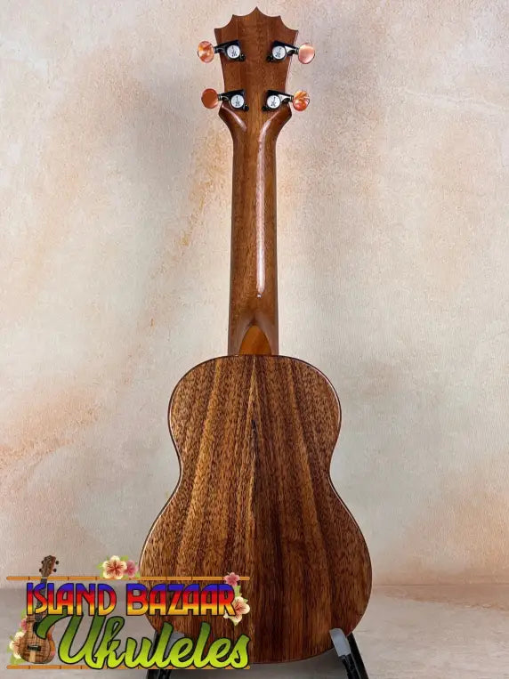 Wooden ukulele with striped grain, showcasing the KoAloha KSM-10 Soprano Ukulele’s Pikake Satin Finish