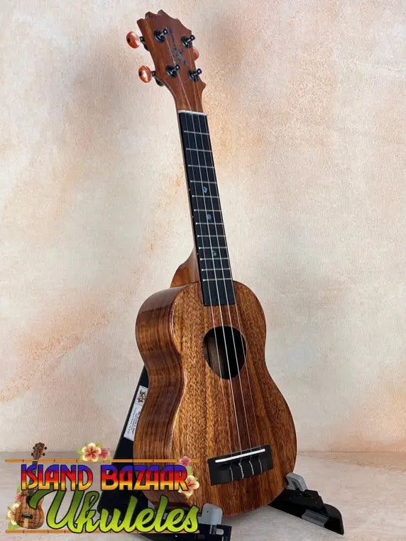 Wooden KoAloha KSM-10 Soprano Ukulele with dark grain and Pikake Satin Finish on stand