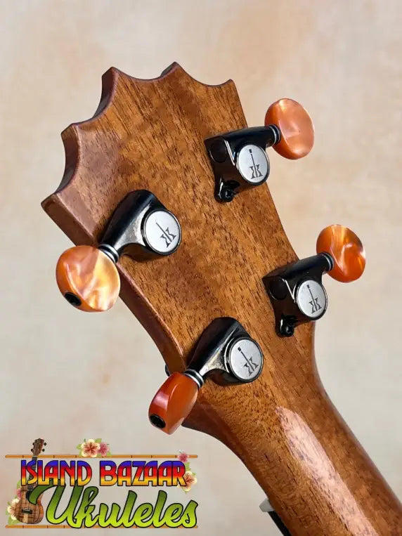 Guitar headstock with amber tuning knobs on KoAloha KSM-10 Soprano Ukulele in Pikake Satin Finish