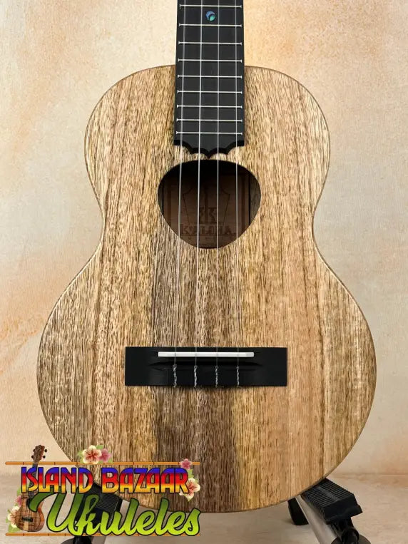 Wooden KoAloha KTM-10RP-MG Tenor Mango Ukulele with natural grain and black fretboard