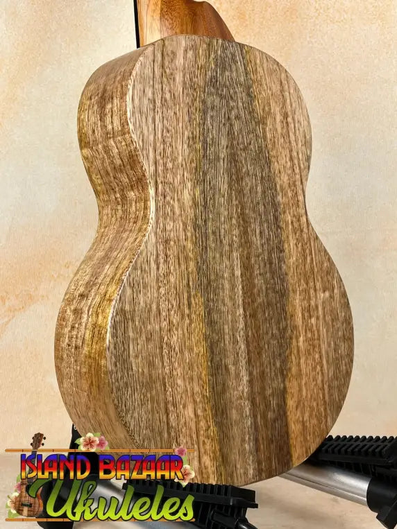 Wooden acoustic guitar showcasing wood grain in KoAloha KTM-10RP-MG Tenor Mango Ukulele