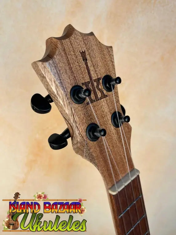 Wooden headstock of KoAloha KTO-10 Opio Tenor Ukulele with black tuning pegs