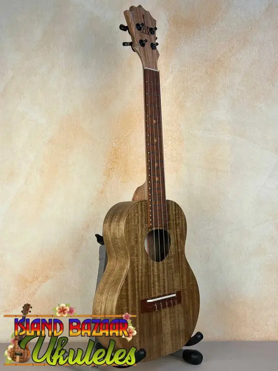 Wooden KoAloha KTO-10 Opio Tenor Ukulele on black stand with gig bag