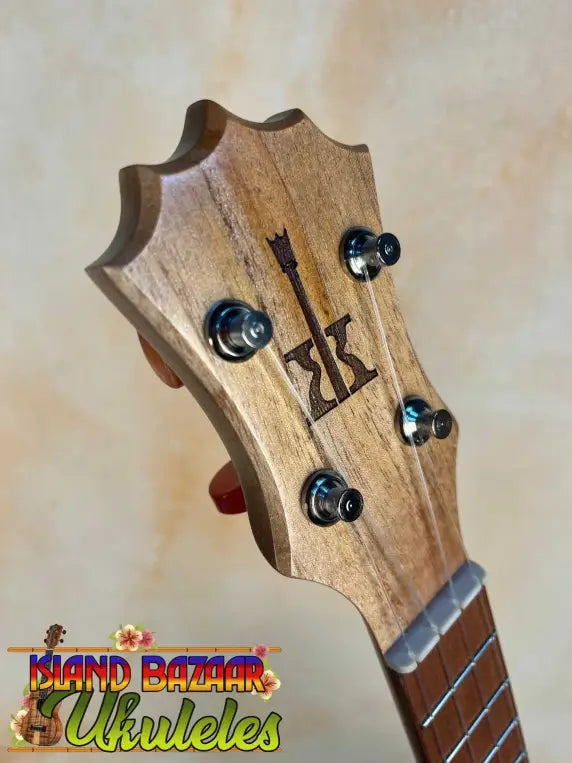Wooden ukulele headstock with black tuning pegs on a KoAloha Opio Concert Ukulele