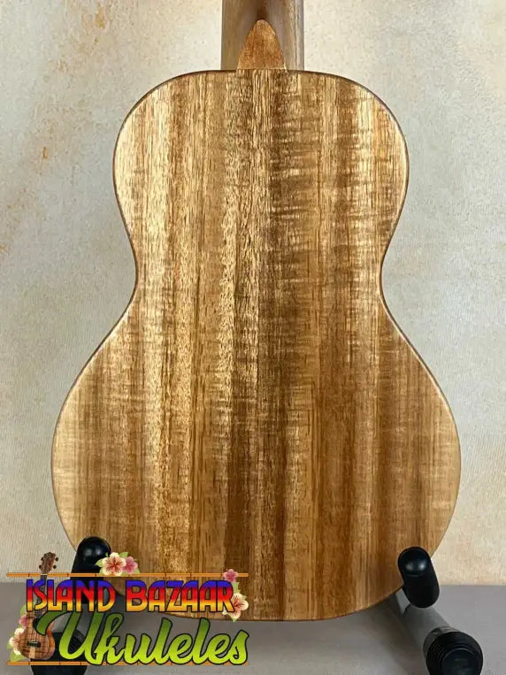 Acoustic guitar with natural wood grain, featured in KoAloha Opio Concert Ukulele