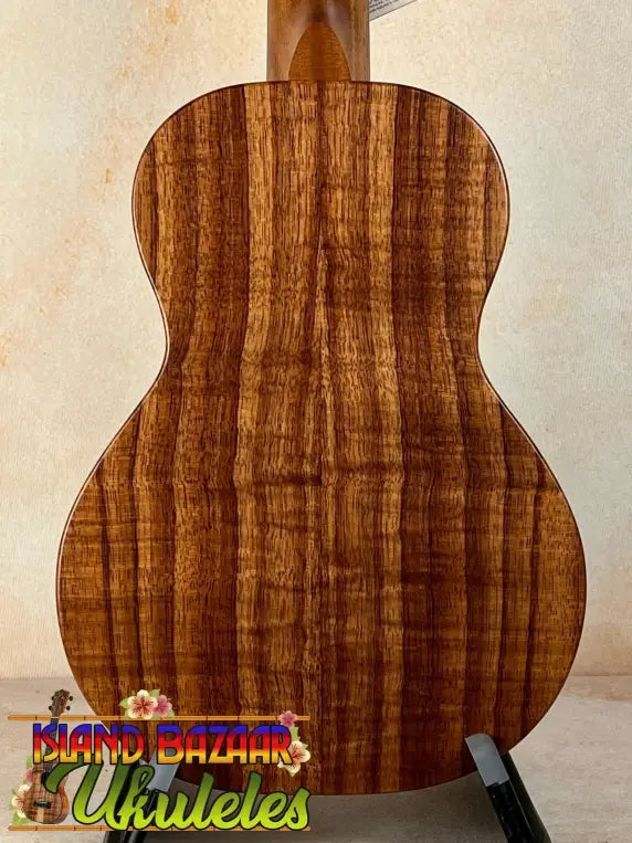 Acoustic guitar featuring richly striped Koa wood back panel of KoAloha Royal Pikake Concert