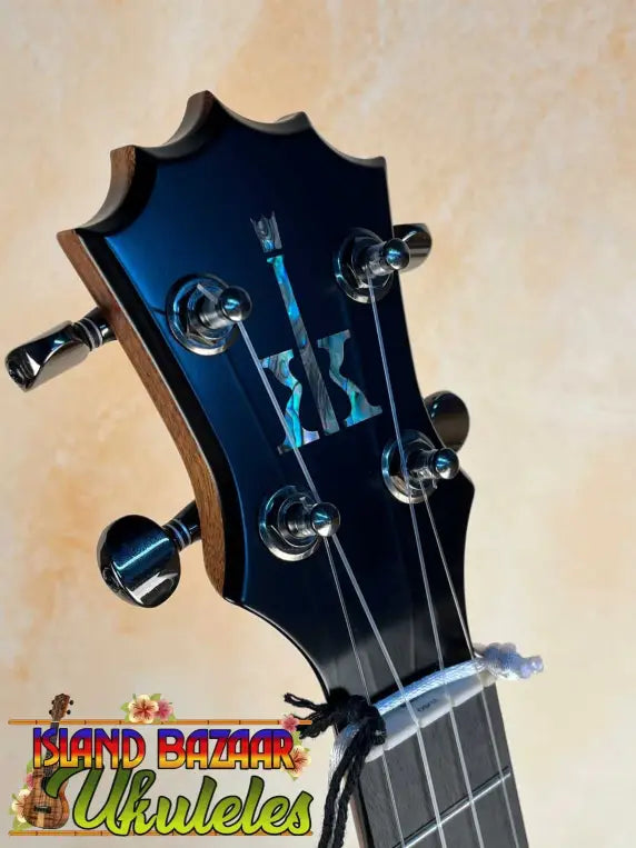 Guitar headstock with black tuning pegs and inlay on KoAloha Royal Pikake Concert Ukulele