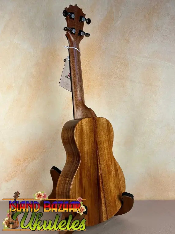 Wooden ukulele on a stand, showcasing the KoAloha Royal Pikake Concert Ukulele