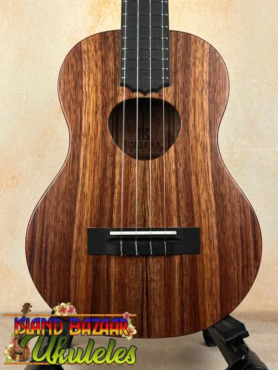 Brown wood ukulele showcasing the Koaloha Royal Pikake Royal Pikake Tenor with solid Hawaiian koa finish