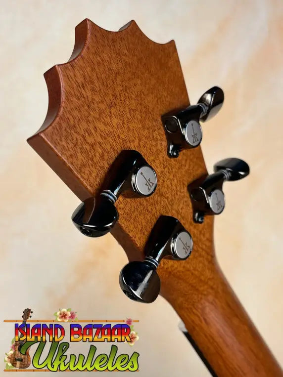 Guitar headstock with black tuning pegs on solid Hawaiian Koa of Koaloha Royal Pikake