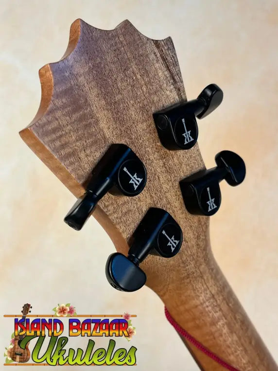 Guitar headstock with black tuning pegs on KoAloha Tenor Opio Solid Acacia Ukulele