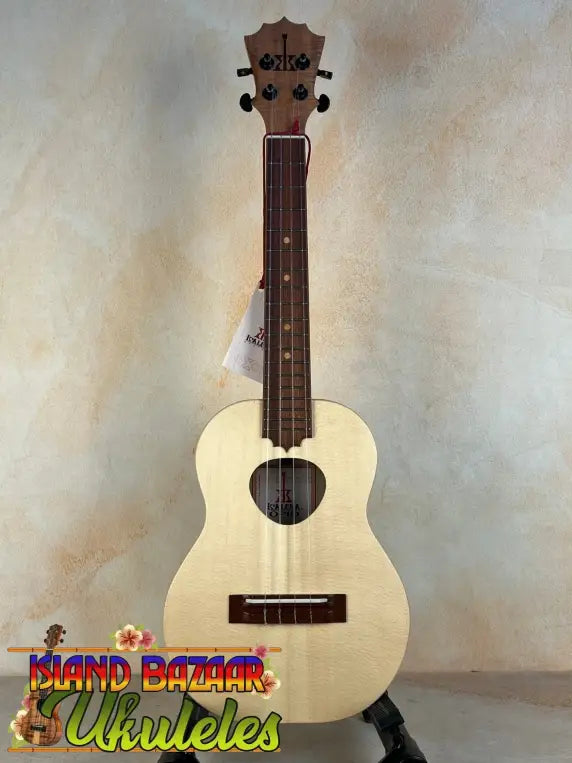 Light-colored wooden KoAloha Tenor Opio ukulele with heart-shaped sound hole