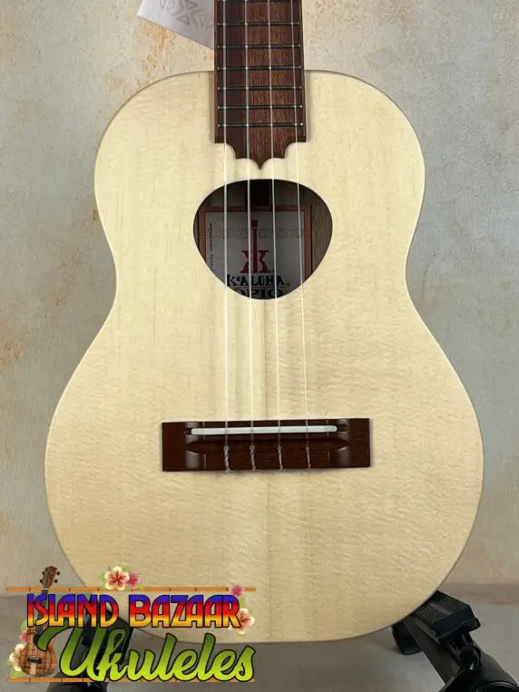 Light-colored wooden KoAloha Tenor Opio with heart-shaped sound hole and case