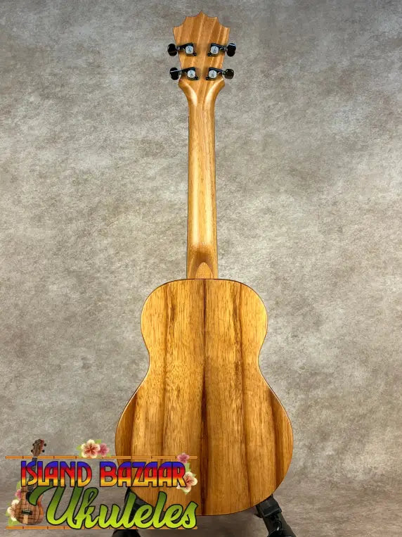 Ukulele with natural wood finish, dark tuning pegs, and visible koa grain, Koaloha Royal Pikake tenor