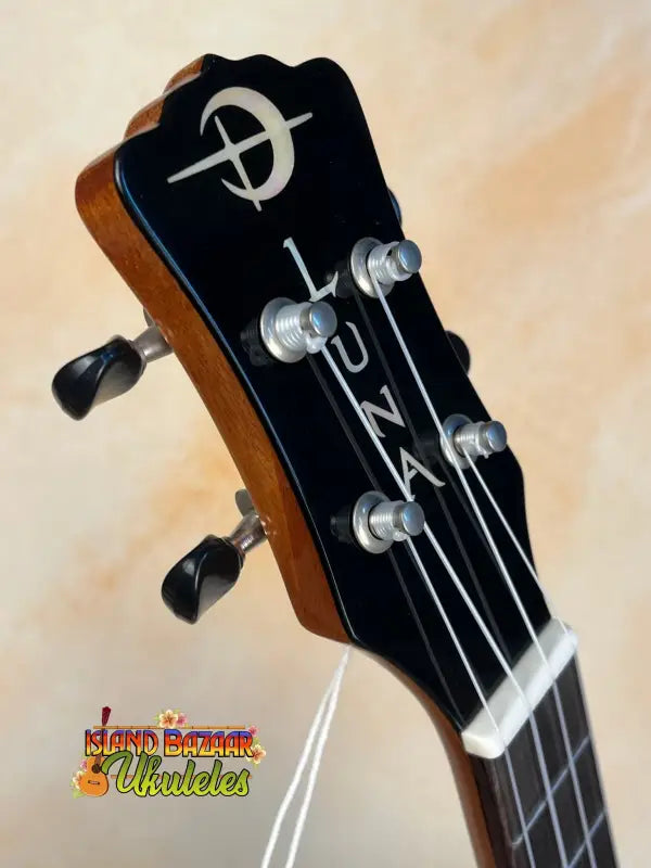 Guitar headstock of Luna Vista Deer Tenor Electric Ukulele with tuning pegs and logo