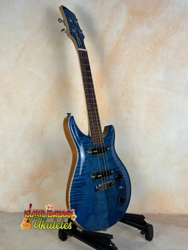 Blue electric guitar with flamed maple top on stand from Mann Electric Tenor Ukulele