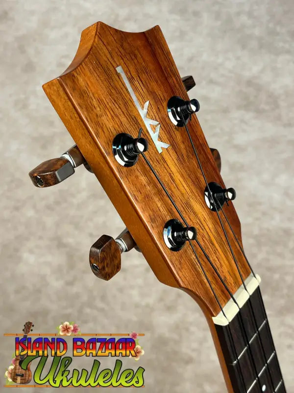 Wooden ukulele headstock on New Kamaka HF-3 Tenor Ukulele with solid koa finish