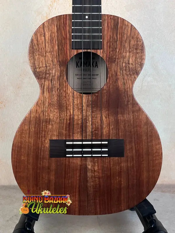 Wooden Kamaka HF-3I Slothead Tenor Ukulele with dark grain and black fretboard