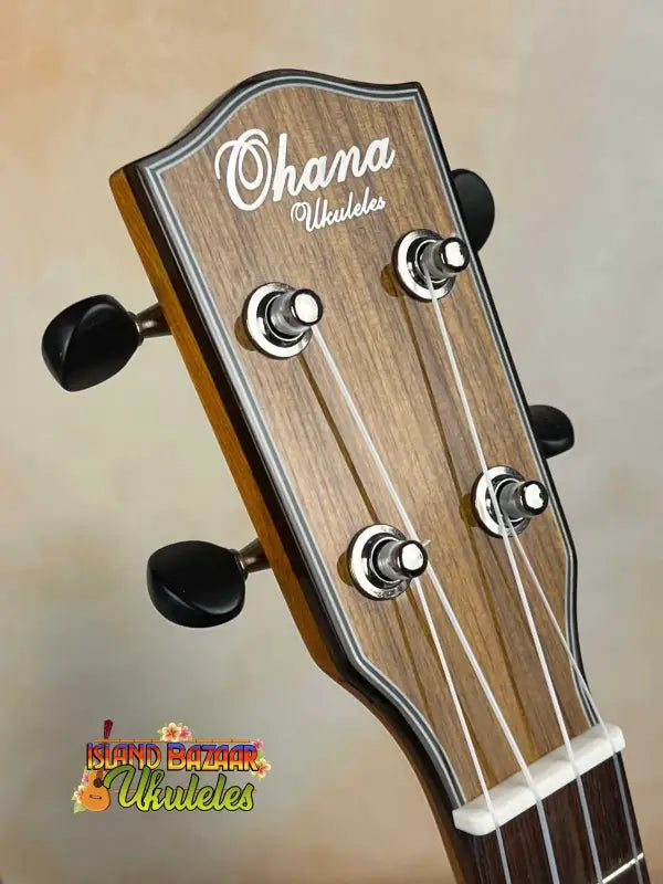 Ohana CK-35G headstock with black tuning pegs and rich wooden grain finish
