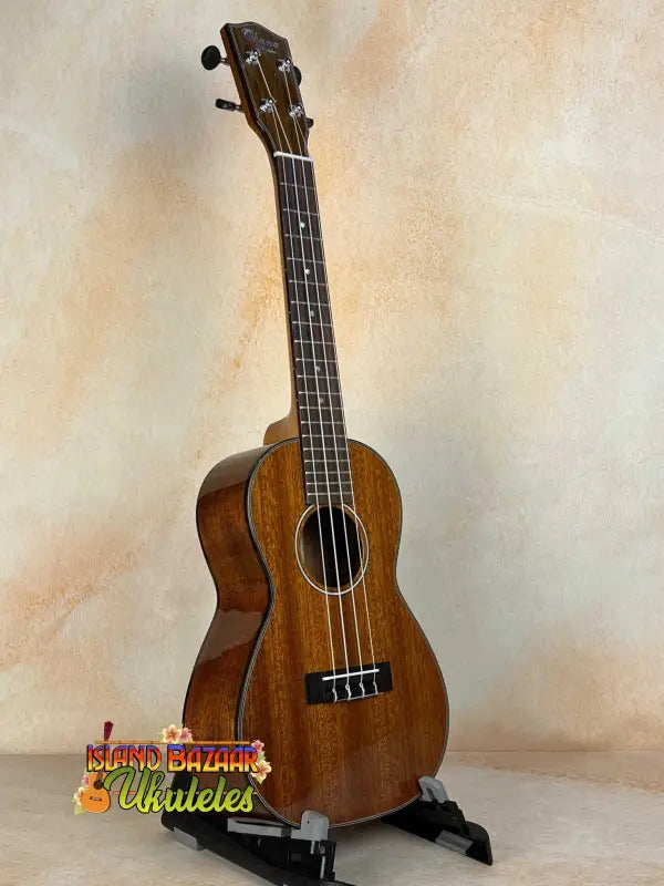 Wooden Ohana CK-35G Solid Mahogany Concert Ukulele on a black stand at Island Bazaar Ukes