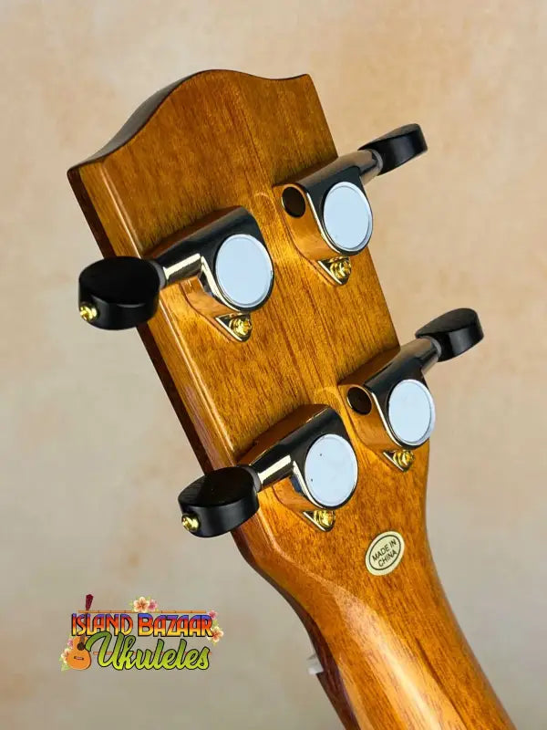 Wooden guitar headstock with black tuning pegs on Ohana CK-370G Concert Ukulele