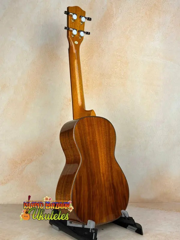 Wooden ukulele on a stand showcasing Ohana CK-370G Concert in Solid Hawaiian Koa
