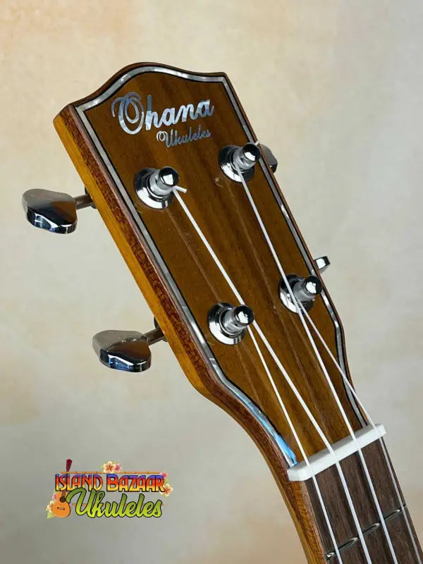 Ohana CK-50G headstock showcasing tuning pegs and strings of solid cedar & rosewood
