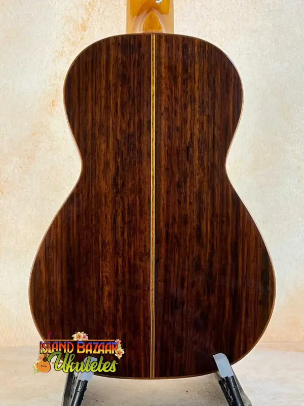 Acoustic guitar featuring rich brown rosewood back, highlighting Ohana CK-50G design
