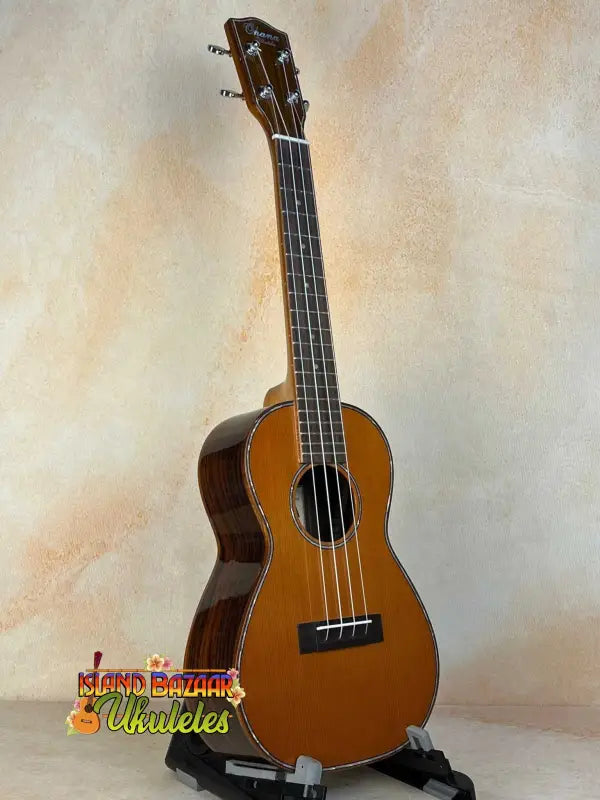 Ohana CK-50G Solid Cedar & Rosewood Concert Ukulele with natural finish and four strings