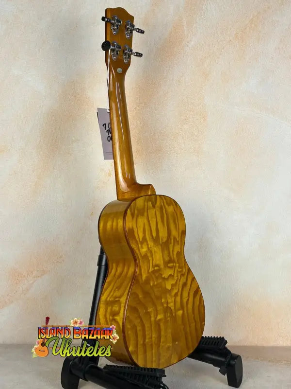 Golden Ohana CK-50WG Concert Ukulele in Cedar & Willow on a black stand