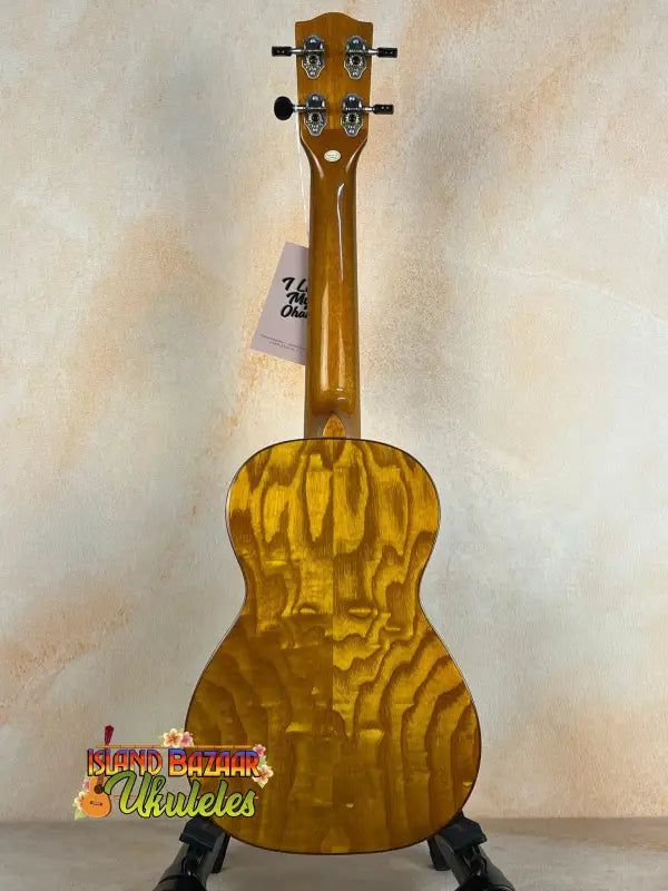 Golden Ohana CK-50WG Concert Ukulele with woodgrain pattern on black stand